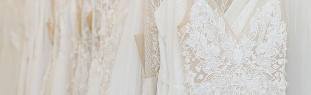 Answering the internet's most asked questions about wedding dress shopping - Revelle Bridal Boutique - Rack of dresses Revelle Bridal
