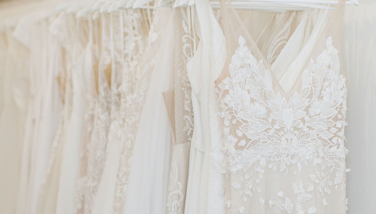 Answering the internet's most asked questions about wedding dress shopping - Revelle Bridal Boutique - Rack of dresses Revelle Bridal