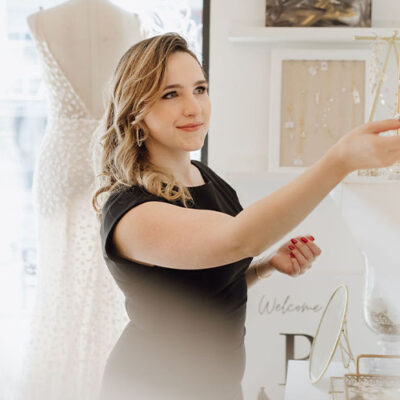 https://revellebridal.com/wp-content/uploads/2021/08/Revelle-Bridal-Boutique-Ottawa-Boho-Modern-Boutique-Bridal-Stylist-Claire-selecting-accessories-for-bride-400x400.jpg