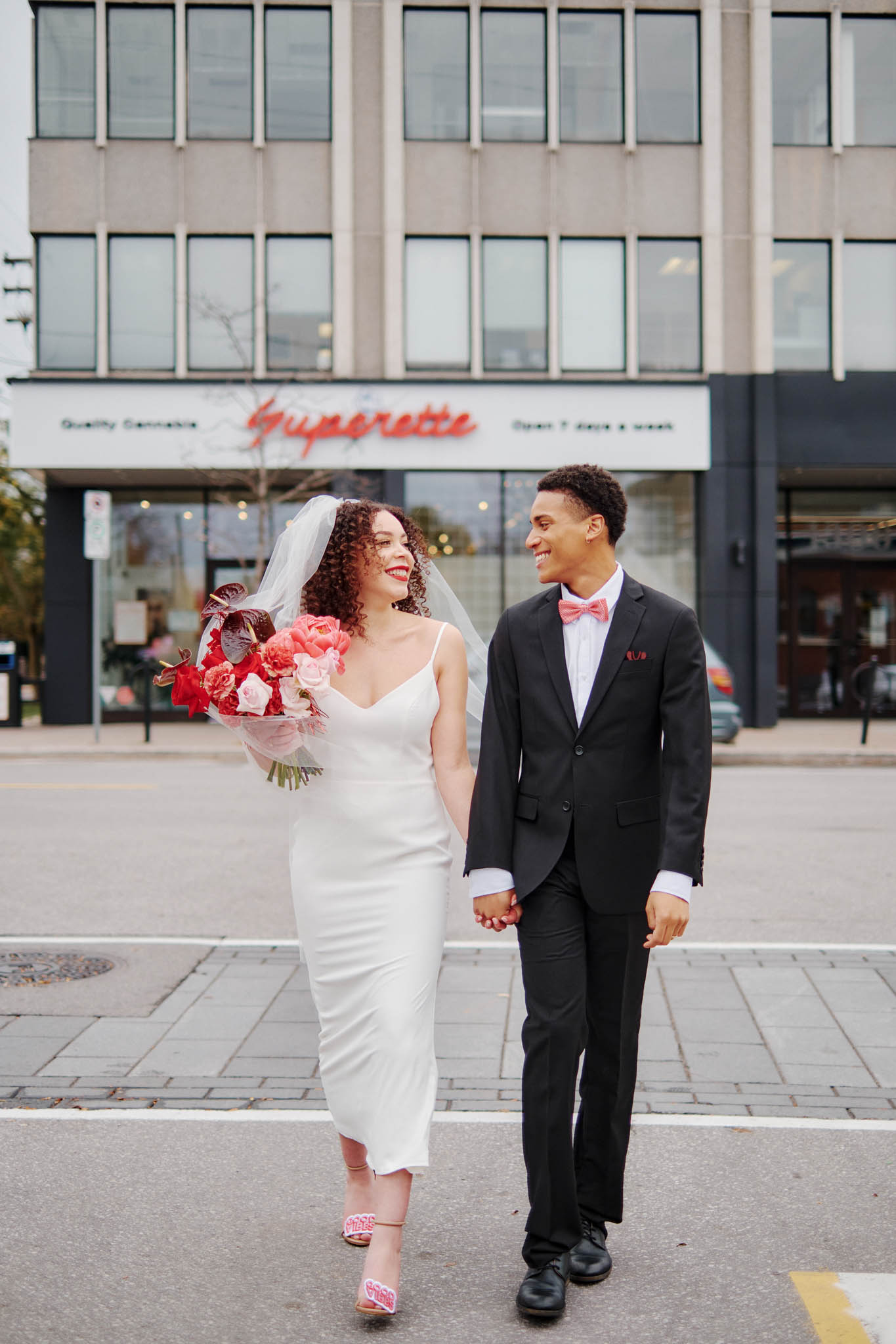 BASH-by-Revelle-BLVD-Maide-Layla-Crepe-Wedding-Gown-Minimalist-Wedding-Dress-Affordable-Luxury-Couple-Walking-Down-Street-Happy
