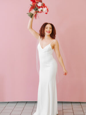 Bash Blvd by Revelle Bride holding pink flower bouquet wearing minimal wedding dress canadian fashion fun