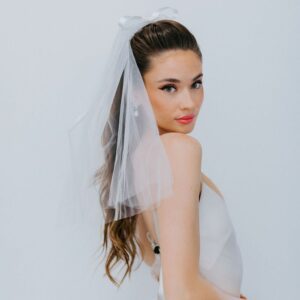 Untamed Petals sweet, simple and classic mini veil hand sewn to a barrette for easy placement. Shipping available across Canada with Revelle Bridal.