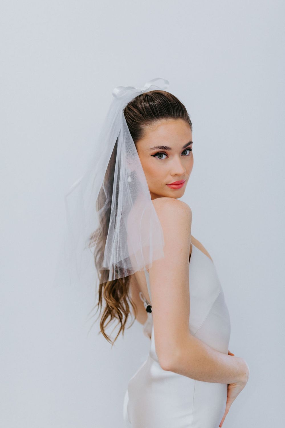 Untamed Petals sweet, simple and classic mini veil hand sewn to a barrette for easy placement. Shipping available across Canada with Revelle Bridal.