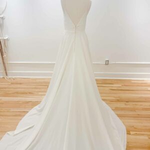 Orenda by Aesling crepe wedding modern wedding dress sample sale revelle bridal on mannequin back and train