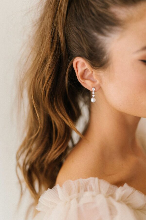 Serenade Earrings by Untamed Petals available for purchase at Revelle Bridal Ottawa Wedding Jewelry Crystal stud earrings with pearl drop Bridal Jewellery