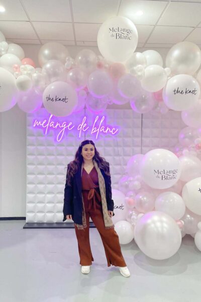 Marisa standing in front of Melange de Blanc Sign NYBFW NYC