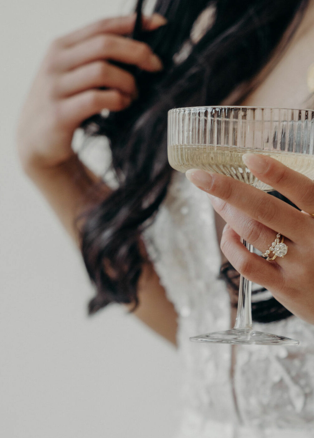 Bride Holding champagne glass wearing lace wedding dress
