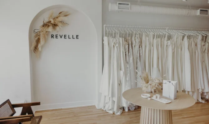 Revelle Bridal Ottawa - Wedding Dress Shop - Luxury Wedding Boutique Westboro - Entrance Dress Rack, Arch, Wedding Dresses Chic Minimalist elegant space